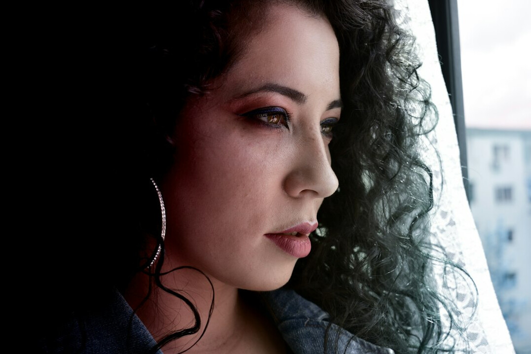 Young woman with curly hair listening attentively