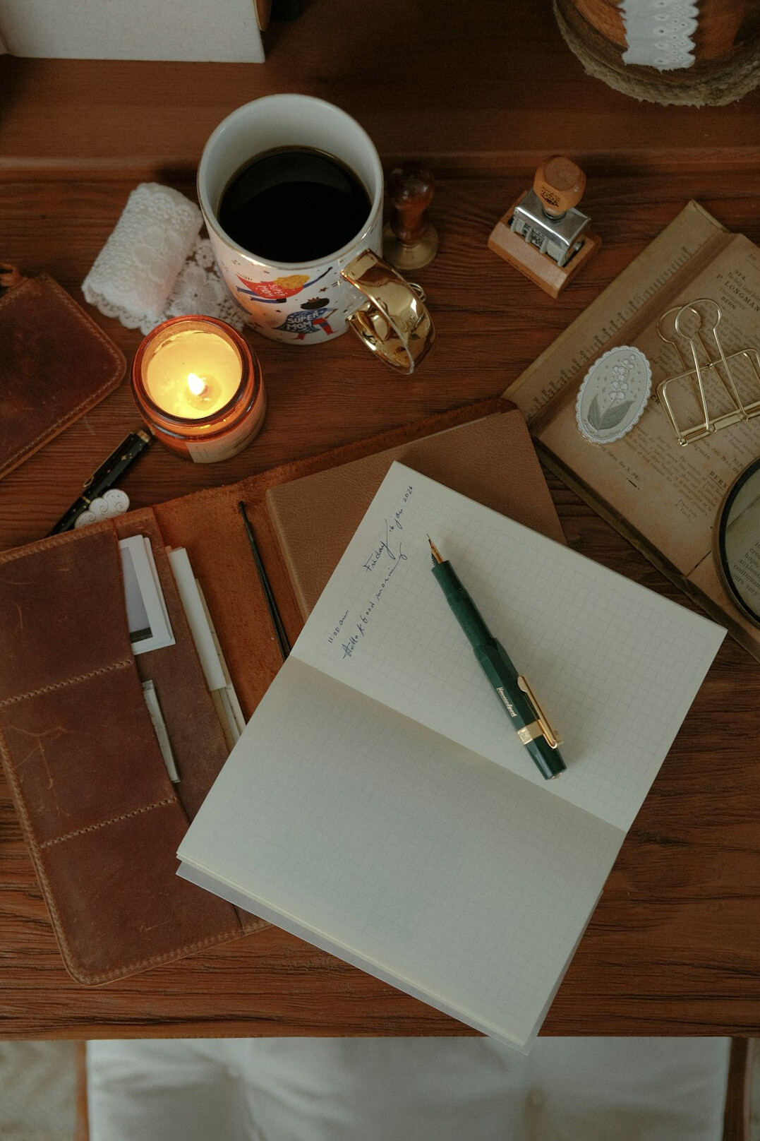 person writing in journal at desk